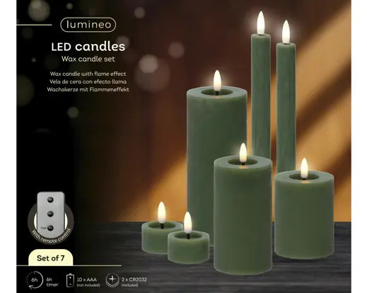 Set of green LED candles with remote control on a gray background