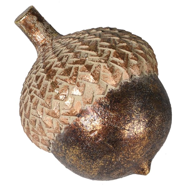 Decorative acorn with a textured surface on a white background