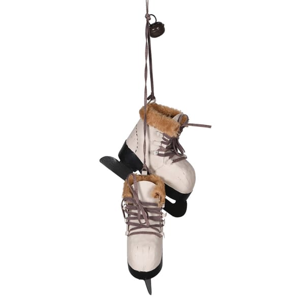 A pair of beige and brown faux fur lined skating boots hanging from a metal wire with a Christmas-themed decoration.
