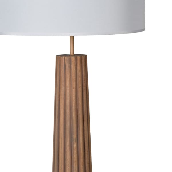 Floor lamp with wooden base and white shade on a white background