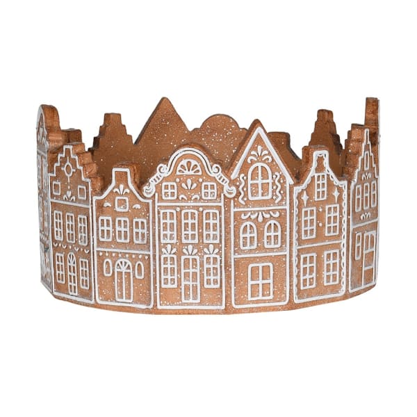 Decorative cake stand with gingerbread house design on a white background