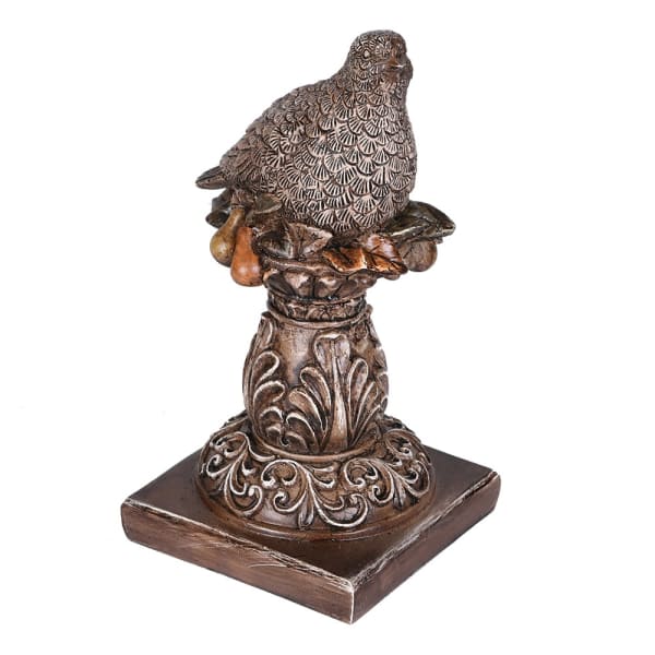 Bronze statue of a dove on a decorative pedestal with intricate details