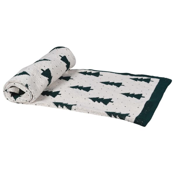 Rolled-up blanket with tree pattern on a white background