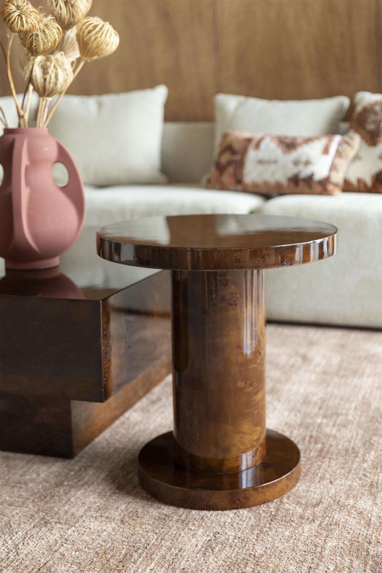 Round wooden side table on a white background