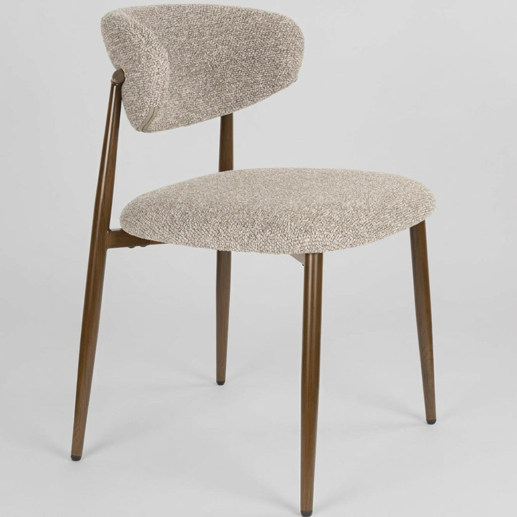 Beige upholstered chair with wooden legs on a white background