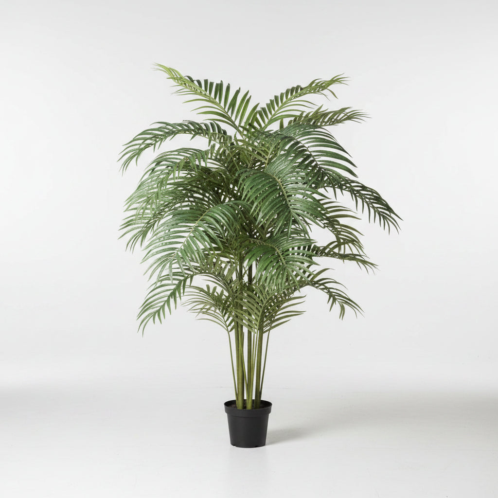 Potted artificial palm plant on a white background