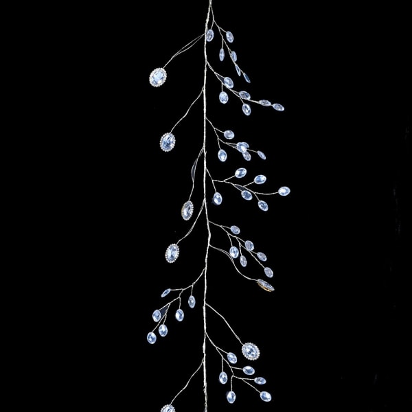 Decorative branch with crystal-like beads on a black background