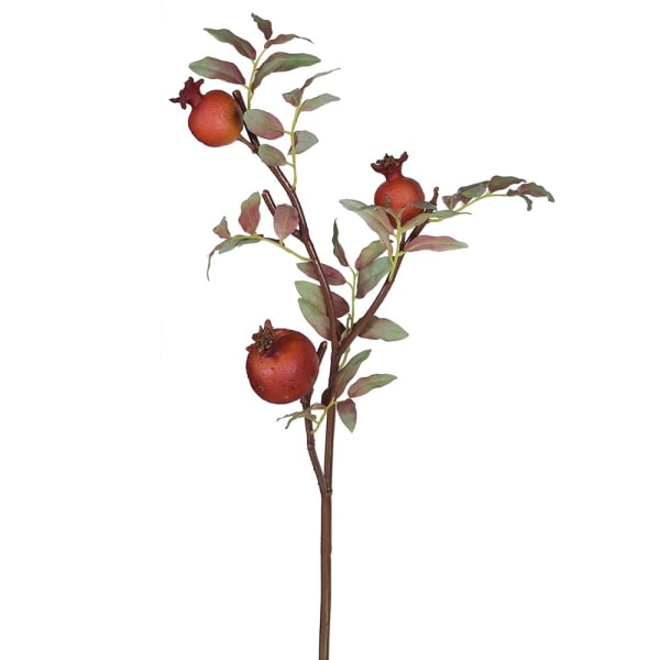 Artificial pomegranate branch with red fruits and green leaves on a white background