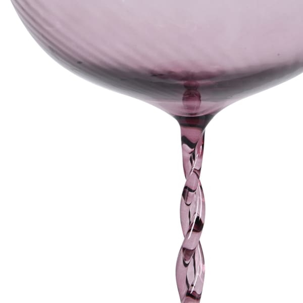 Set of four pink cocktail glasses with twisted stems on a white background